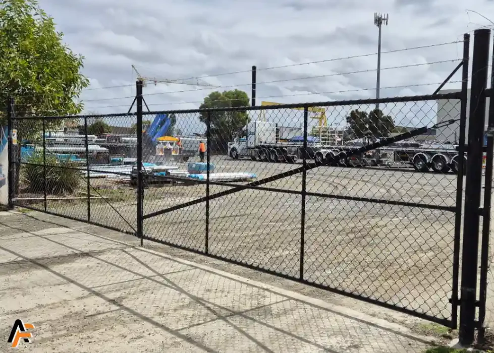 Commercial fencing with secure chain wire gate providing durable perimeter protection for business properties on the Gold Coast.