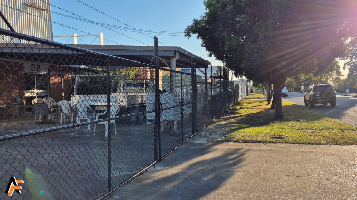 Heavy-duty chain wire security fencing with barbed wire top, providing secure perimeter protection for Brisbane and Gold Coast.