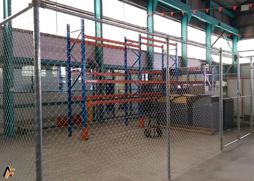 a security cage installed within a warehouse to store equipment. a chain wire double gate has also been installed on the gold coast.