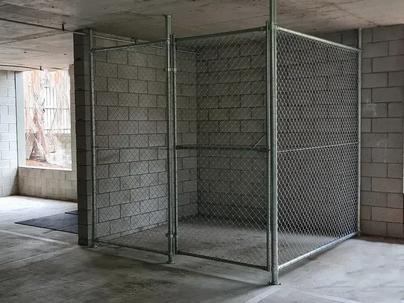 Chain wire storage cage inside concrete basement – ideal for Oxenford apartment car parks and secure storage areas