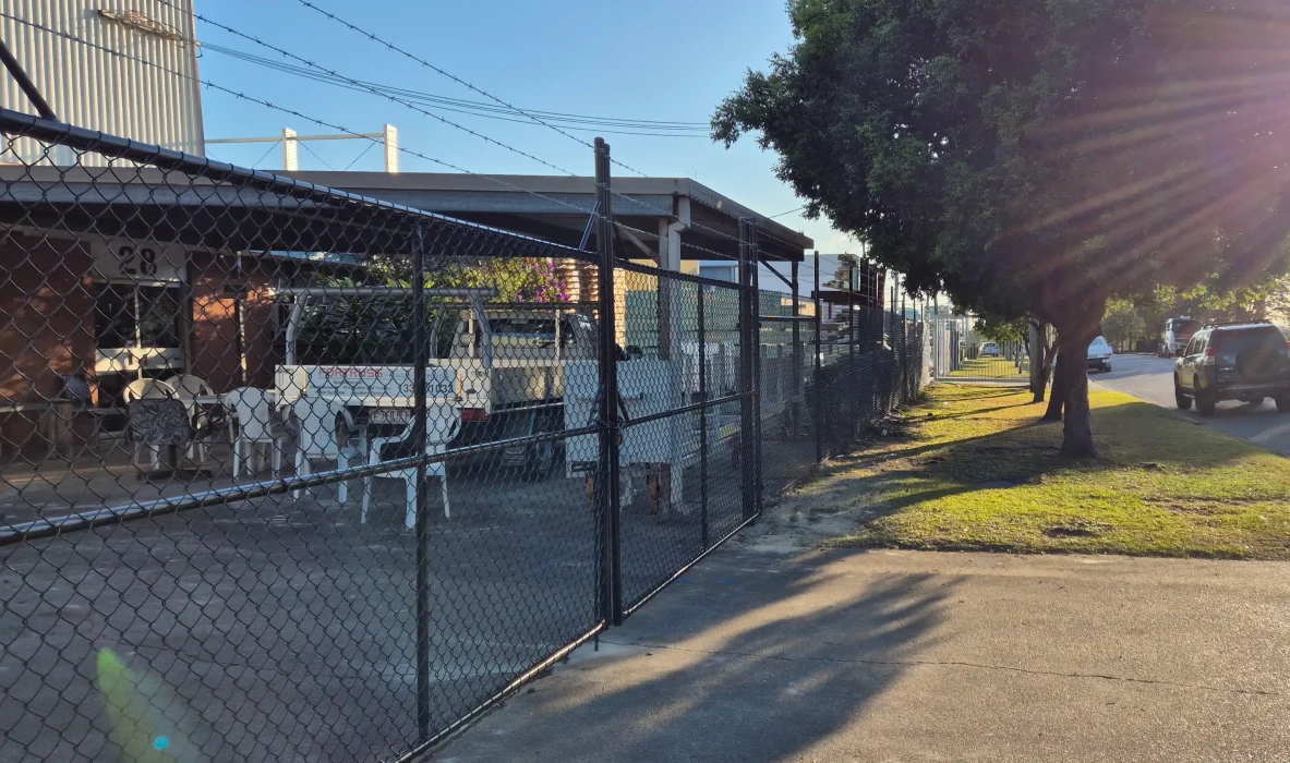 Black chain wire fencing with barbed wire, suited for Oxenford commercial sites and secure outdoor areas
