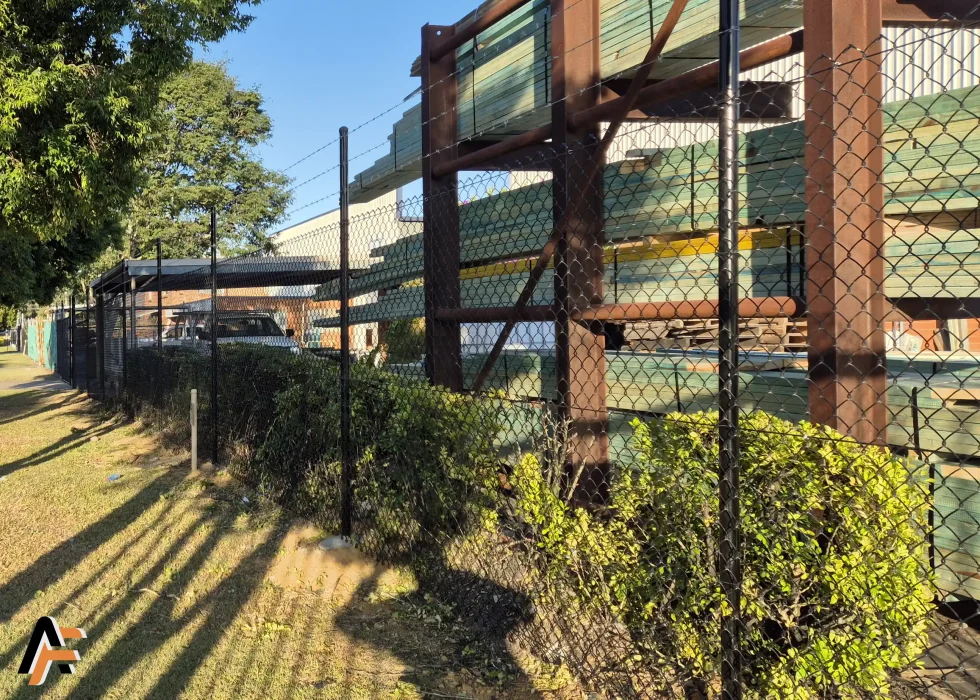 Chain wire security fencing protecting a timber storage yard in Brisbane, designed for durable boundary security around commercial sites.