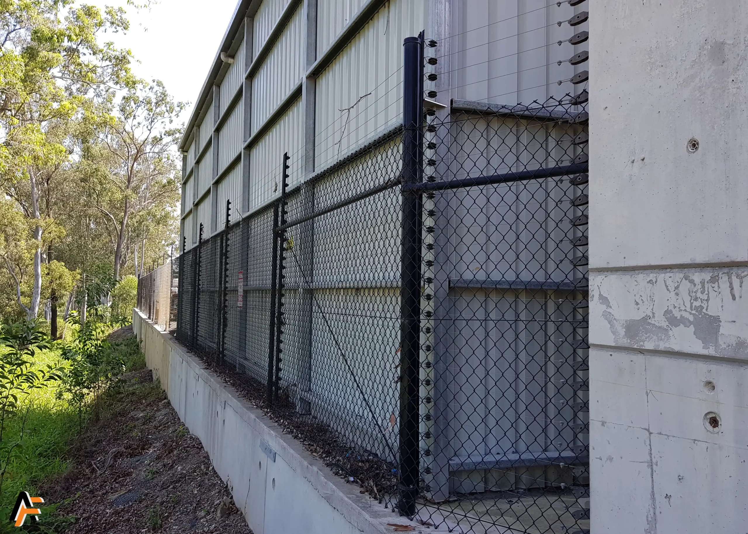 black pvc coated chain link electrified fence installed in brisbane by apollo fencing