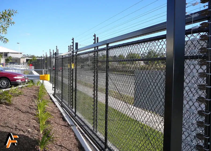 Electric fencing installed in the gold coast with electrified wires and a sliding gate. black finish